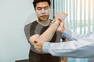 Asian physiotherapists check the elbows of patients who have undergone orthopedic rehabilitation photo