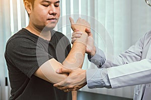 Asian physiotherapists check the elbows of patients who have undergone orthopedic rehabilitation photo