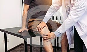 Asian physiotherapists are checking patients` knees