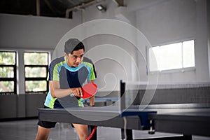 Asian ping pong players in a position ready to compete