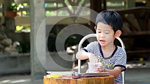 Asian play game or toy alone joyfully