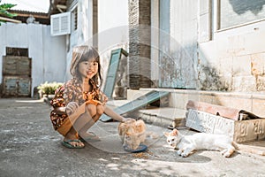 Asian playing with cat at java traditional home