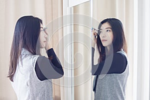 Asian portrait beautiful woman making make-up with brush on eyeb