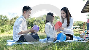 Asian portrait family trip father mother and daughter enjoy relaxation playing balloons with family to lifestyle freedom family