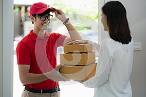 Asian postman deliver a paper box postal to customer