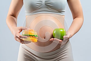 Asian pregnant woman choose healthy food or junk food