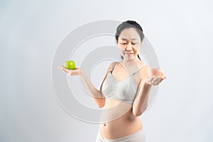 Asian pregnant woman eating fruit for her and infant healthy