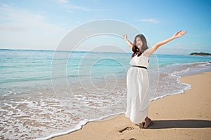Asian pregnant woman enjoying in the beach with open arms