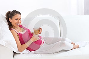 Asian pregnant woman has a rest at home with cup pf tea