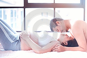 Asian pregnant woman with husband at home
