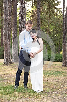 Asian pregnant women with caucasian husband standing outdoor