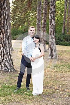 Asian pregnant women with caucasian husband standing outdoor