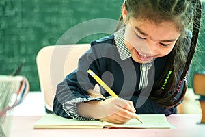 Asian primary school student studying homework in classroom photo