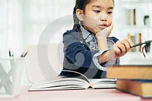 Asian primary school student studying homework in classroom