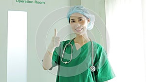 Asian professional female surgeon standing in front of the operating room