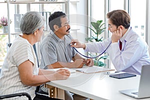 Asian professional successful male doctor in white lab coat with stethoscope hold medicine pill bottle showing explaining dosage