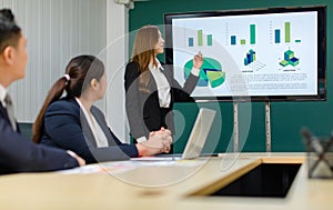 Asian professional successful smart confident female businesswoman presenter lecturer in formal business suit standing presenting