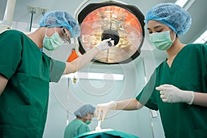 Asian Professional surgeons team performing surgery in the operating room, surgeon, Assistants, and Nurses Performing Surgery on a