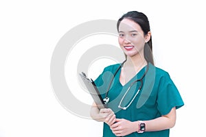 Asian professional woman doctor standing smiling in a green lab shirt, holding patient documents in hand. Health care concept