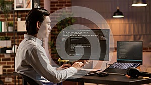 Asian programmer using binary code to script security system