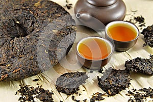 Asian Pu-erh tea still life with dishware and dry leaves