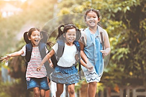 Asian pupil kids with backpack running