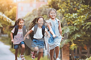 Asian pupil kids with backpack running