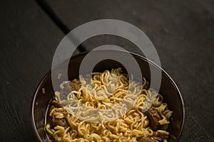 Asian quick noodles on wood background photo