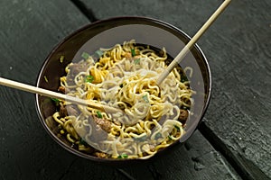 Asian quick noodles on wood background photo