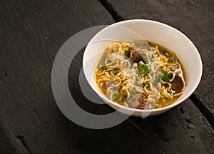 Asian quick noodles on wood background photo