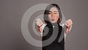 Asian restaurant hostess showing thumbs down and dislike sign