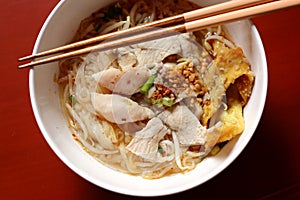 Asian rice noodle soup with pork, fish ball and crisps dumpling.