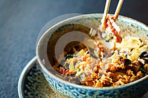 Asian rice with pork, Mu-err mushrooms, napa cabbage, pickled bamboo shoots, spinach, Teriyaki, sweet chili sauce, onion