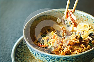 Asian rice with pork, Mu-err mushrooms, napa cabbage, pickled bamboo shoots, spinach, Teriyaki, sweet chili sauce, onion