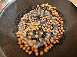 Asian roasted chestnuts in a big frying pan