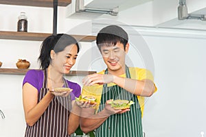 Asian romantic and lovely couple enjoy and happy cooking food in the kitchen