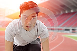 Asian runner men with focus eyes committed forward