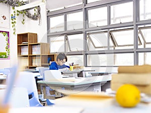 Asian school boy studying in classroom