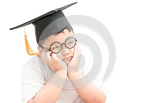 Asian school kid graduate bored with graduation cap isolated