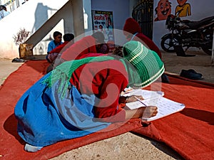 Asian school students writing during common test at open area class in India January 2020