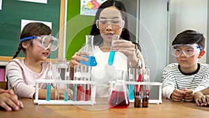 Asian school teacher and students in science class