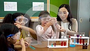 Asian school teacher and students in science class