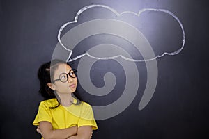 Asian schoolgirl looking at an empty cloud bubble