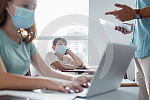Asian schoolkids in medical mask looking