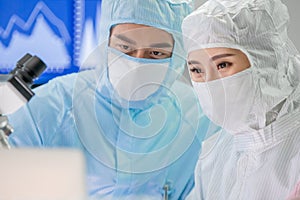 Asian scientist with cleanroom suit