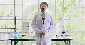 Asian scientist introducing his lab to the camera.