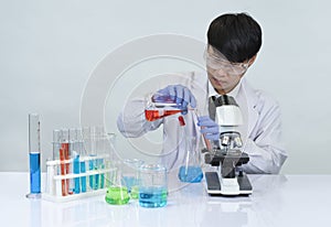 asian scientist working in chemical laboratory,doing chemistry experiments with microscope