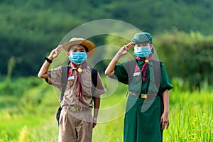 Asian Scout  wearing a mask and Show respect, new normal