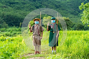 Asian Scout  wearing a mask and Show scout symbol, new normal