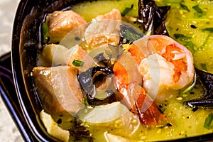 Asian seafood soup with spics and herbs